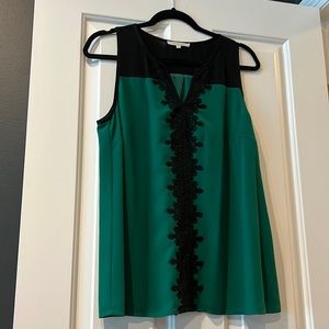 Sleeveless blouse green with black trim